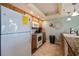 White appliances and wood cabinets in this galley kitchen at 18610 Gulf Blvd # 402, Indian Shores, FL 33785