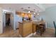 Bright kitchen with granite countertops, wood cabinets, and island at 18610 Gulf Blvd # 402, Indian Shores, FL 33785
