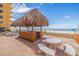 Beach access path with dune vegetation and footprints at 18610 Gulf Blvd # 402, Indian Shores, FL 33785
