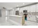 Modern kitchen with white cabinets, quartz countertops, and stainless steel appliances at 2138 -1 W Beach St, Tampa, FL 33607