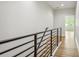 Upstairs hall with wood floors and modern metal railing at 2138 -1 W Beach St, Tampa, FL 33607