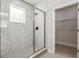 Walk-in shower with marble tile and glass enclosure at 2138 -1 W Beach St, Tampa, FL 33607