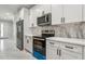 Modern kitchen with white cabinets, quartz countertops, and stainless steel appliances at 2138 -1 W Beach St, Tampa, FL 33607