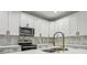 Modern kitchen with white cabinets, quartz countertops and gold faucet at 2138 -1 W Beach St, Tampa, FL 33607