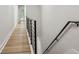 Light-filled hallway with hardwood floors and modern railing at 2138 -1 W Beach St, Tampa, FL 33607