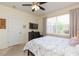 Bedroom with a queen bed, ceiling fan, TV, and built-in shelving at 1908 Sterling Glen Ct, Sun City Center, FL 33573