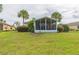 Home exterior showcasing a screened patio and lush landscaping at 1908 Sterling Glen Ct, Sun City Center, FL 33573