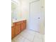 Bathroom with wood vanity, tiled floor, and shower at 1908 Sterling Glen Ct, Sun City Center, FL 33573