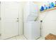 Laundry room with stacked washer and dryer at 1908 Sterling Glen Ct, Sun City Center, FL 33573