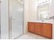 Bathroom with walk-in shower and wood vanity at 1908 Sterling Glen Ct, Sun City Center, FL 33573