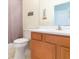 Bathroom with wood vanity, toilet, and shower/tub at 1908 Sterling Glen Ct, Sun City Center, FL 33573