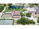 Community tennis courts near a pond and clubhouse at 1908 Sterling Glen Ct, Sun City Center, FL 33573