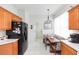 Eat-in kitchen with wood cabinetry, appliances, and a breakfast nook at 1908 Sterling Glen Ct, Sun City Center, FL 33573