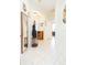 Well-lit entryway featuring a mirror and coat rack at 1908 Sterling Glen Ct, Sun City Center, FL 33573