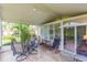 Spacious screened patio with seating area, pond view, and access to interior at 1908 Sterling Glen Ct, Sun City Center, FL 33573