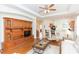 Spacious living room with hardwood floors and an entertainment center at 1908 Sterling Glen Ct, Sun City Center, FL 33573