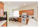 Eat-in kitchen with wood cabinetry, appliances, and a breakfast nook at 1908 Sterling Glen Ct, Sun City Center, FL 33573