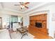 Bright living room with hardwood floors, comfortable seating and access to a sunroom at 1908 Sterling Glen Ct, Sun City Center, FL 33573
