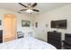 Bedroom with a queen bed, ceiling fan, TV, and built-in shelving at 1908 Sterling Glen Ct, Sun City Center, FL 33573