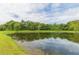 Tranquil pond reflecting the sky and trees at 1908 Sterling Glen Ct, Sun City Center, FL 33573