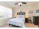 Spacious bedroom with a queen bed, ceiling fan, and ample closet space at 1908 Sterling Glen Ct, Sun City Center, FL 33573