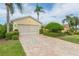 Two car garage with a paved driveway at 1908 Sterling Glen Ct, Sun City Center, FL 33573