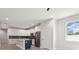 Modern kitchen with white cabinets, a large island, and stainless steel appliances at 2138 - 2 W Beach St, Tampa, FL 33607