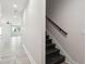 Clean hallway featuring dark wood stairs and a modern metal railing at 2138 - 2 W Beach St, Tampa, FL 33607