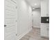Bright hallway with white walls and grey tile floors at 2138 - 2 W Beach St, Tampa, FL 33607