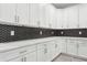 White shaker cabinets, quartz countertops, and a stylish black and white backsplash at 2138 - 2 W Beach St, Tampa, FL 33607
