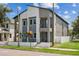 Modern two-story house with gray siding and a white fence at 2138 - 2 W Beach St, Tampa, FL 33607