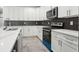 Modern kitchen with white cabinets, quartz countertops, and stainless steel appliances at 2138 - 2 W Beach St, Tampa, FL 33607