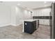 Modern kitchen with white cabinets, stainless steel appliances, and a large island at 2138 - 2 W Beach St, Tampa, FL 33607