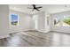 Bright bedroom with hardwood floors, ceiling fan, and multiple windows at 2138 - 2 W Beach St, Tampa, FL 33607