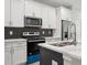 Modern kitchen with white cabinets, stainless steel appliances, and quartz countertops at 2138 - 2 W Beach St, Tampa, FL 33607