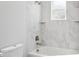 Clean bathroom with white toilet and marble shower/tub combo at 2138 - 2 W Beach St, Tampa, FL 33607