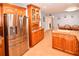 Modern kitchen with stainless steel refrigerator and ample wood cabinetry at 7519 Harbor View Way, Seminole, FL 33776
