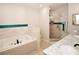 Bright bathroom features a soaking tub with tile surround and separate glass-enclosed shower at 7519 Harbor View Way, Seminole, FL 33776