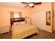 Comfortable bedroom with a ceiling fan, window, closet, and carpet flooring at 7519 Harbor View Way, Seminole, FL 33776