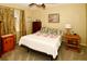 Bedroom with double bed, window with curtains, and wood nightstand at 7519 Harbor View Way, Seminole, FL 33776