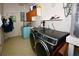 Bright laundry room, featuring washer, dryer, and storage cabinets at 7519 Harbor View Way, Seminole, FL 33776