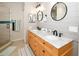 Modern bathroom with double sinks and a walk-in shower at 7519 Harbor View Way, Seminole, FL 33776