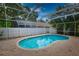 Inviting screened-in pool offers a refreshing escape with brick paver decking at 7519 Harbor View Way, Seminole, FL 33776