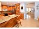 Modern kitchen with island, wood cabinets, and granite countertops at 7519 Harbor View Way, Seminole, FL 33776