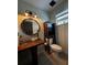 Powder room with wood vanity, glass bowl sink, and updated fixtures and finishes at 8945 Overlook Dr, Wesley Chapel, FL 33545