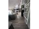 Modern kitchen with stainless steel appliances, gray cabinets, granite counters and wood look floors at 8945 Overlook Dr, Wesley Chapel, FL 33545