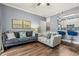 Living room with grey sofas, hardwood floors and kitchen bar at 17104 Carrington Park Dr # 520, Tampa, FL 33647