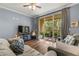 Living room with hardwood floors, comfy sofas, and access to a balcony at 17104 Carrington Park Dr # 520, Tampa, FL 33647