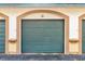 Private garage with teal door and arched entryway at 17104 Carrington Park Dr # 520, Tampa, FL 33647