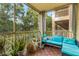 Screened balcony with teal sofa and potted plants at 17104 Carrington Park Dr # 520, Tampa, FL 33647